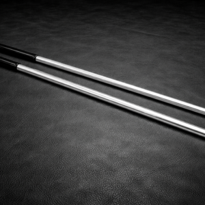 aluminum impact cane with black grip on leather background