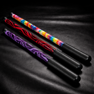 24 inch Delrin graphic pattern cane in tie dye red black swirl and purple black swirl on black leather background